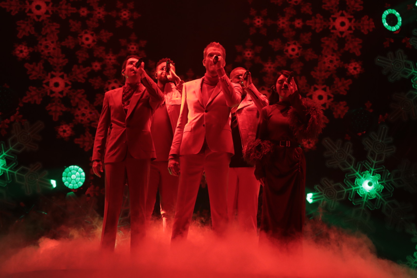 Pentatonix on stage, singing with smoke blowing at their feet.