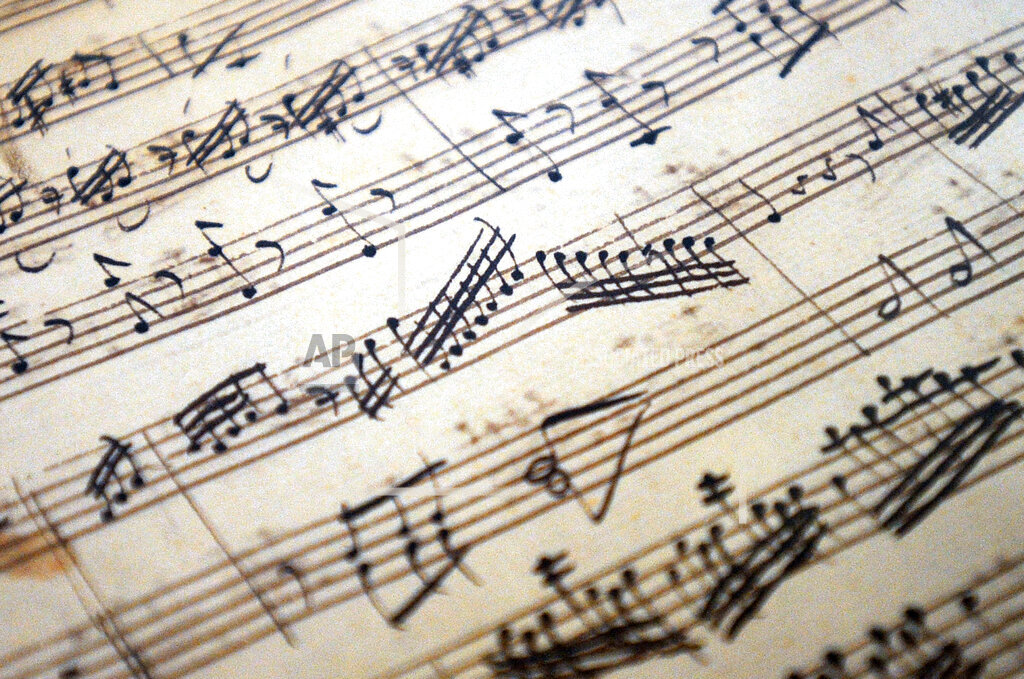 A piece of sheet music with staff lines and notes.