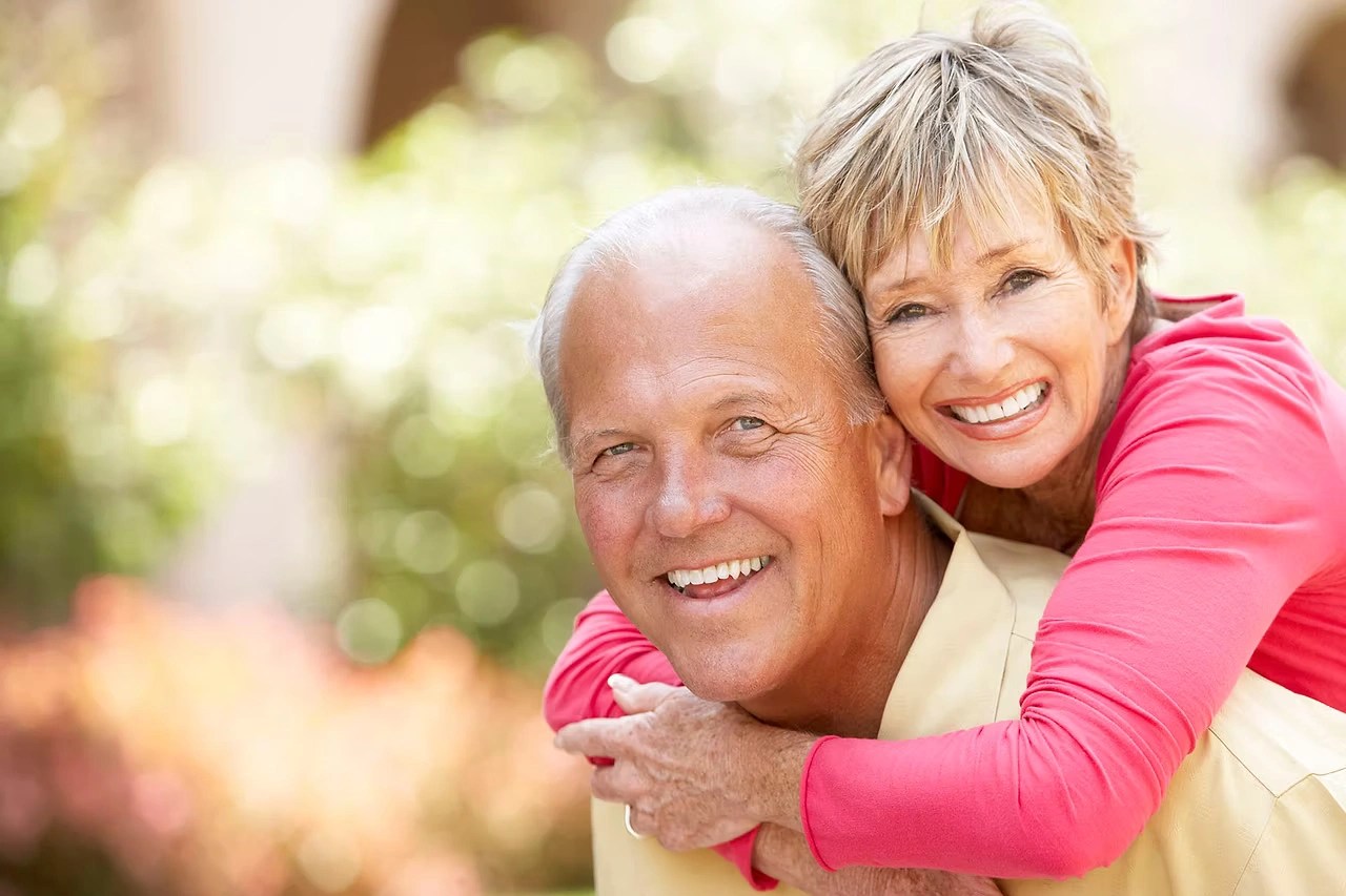 Senior couple hugging outside