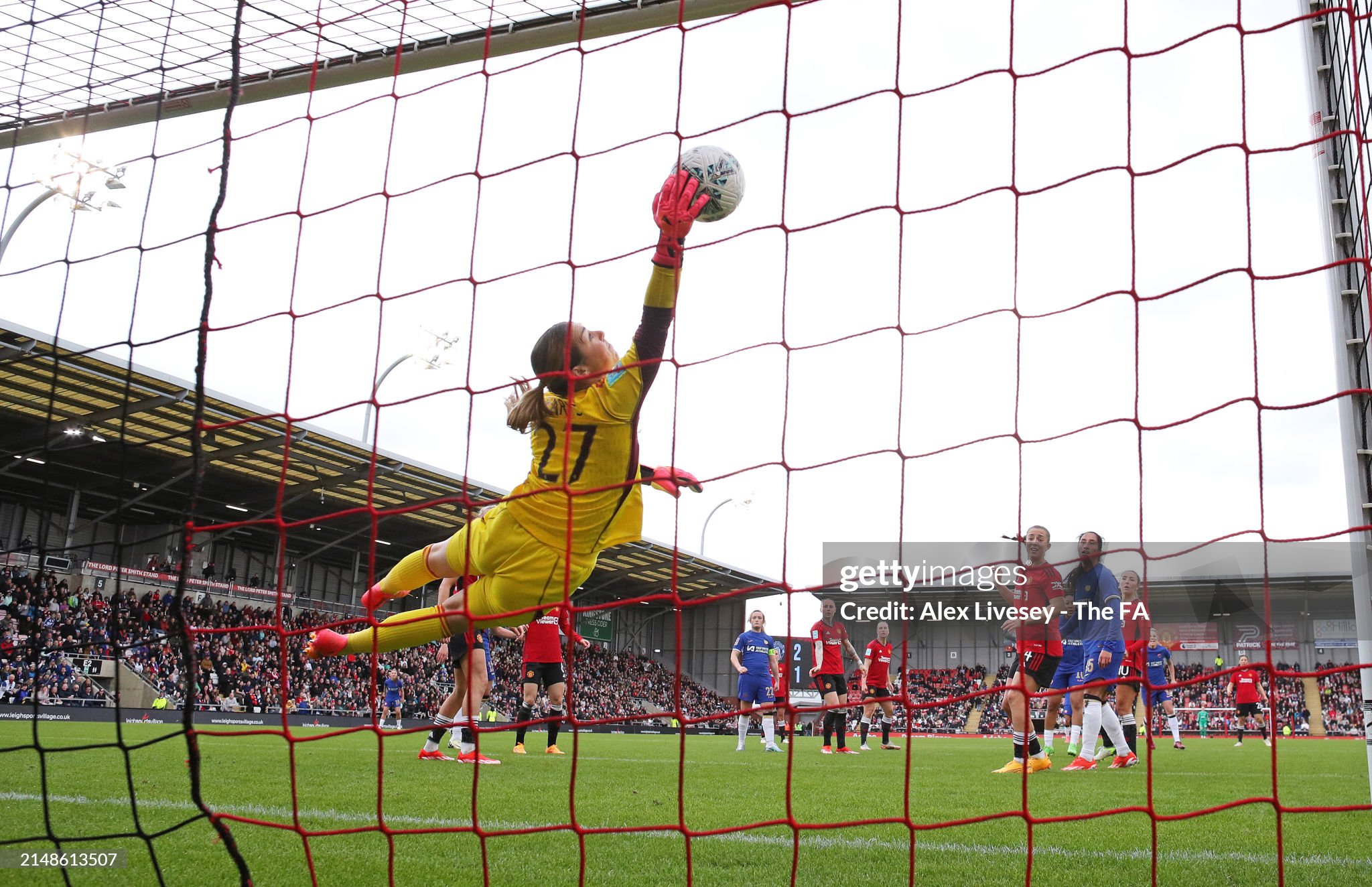 Mary Earps of Manchester United makes a vital save from a header from Lauren James of Chelsea during the Adobe Women's FA Cup Semi Final match between Manchester United and Chelsea at Leigh Sports Village on April 14, 2024 in Leigh, England.