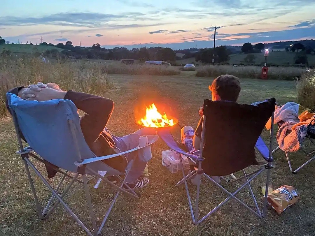 After a bust day at Alton Towers sit around a cosy camp fire as the sun sets