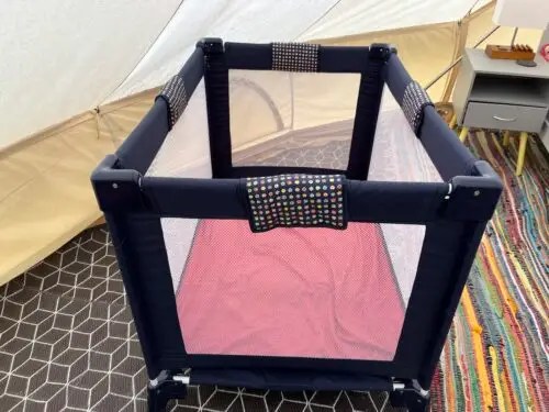 Blue folding travel cot