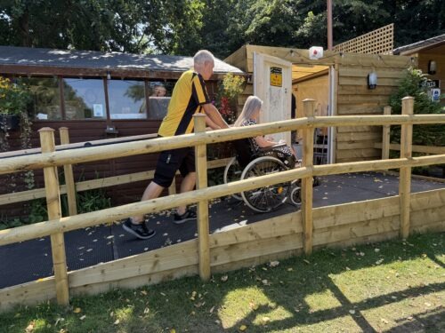 Wheelchair user accessing the family/accessible shower and toilet room