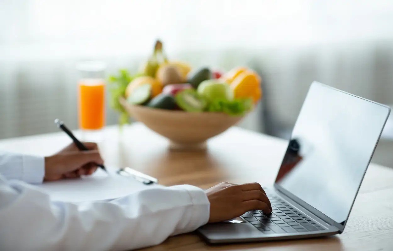 laptop and bowl of fruit