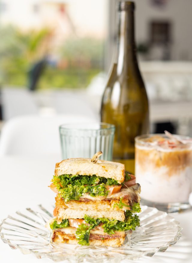 Triple-decker sandwich with fresh lettuce, tomato and toasted bread, served with an iced drink at Spud's Coffee in Fort Lauderdale.