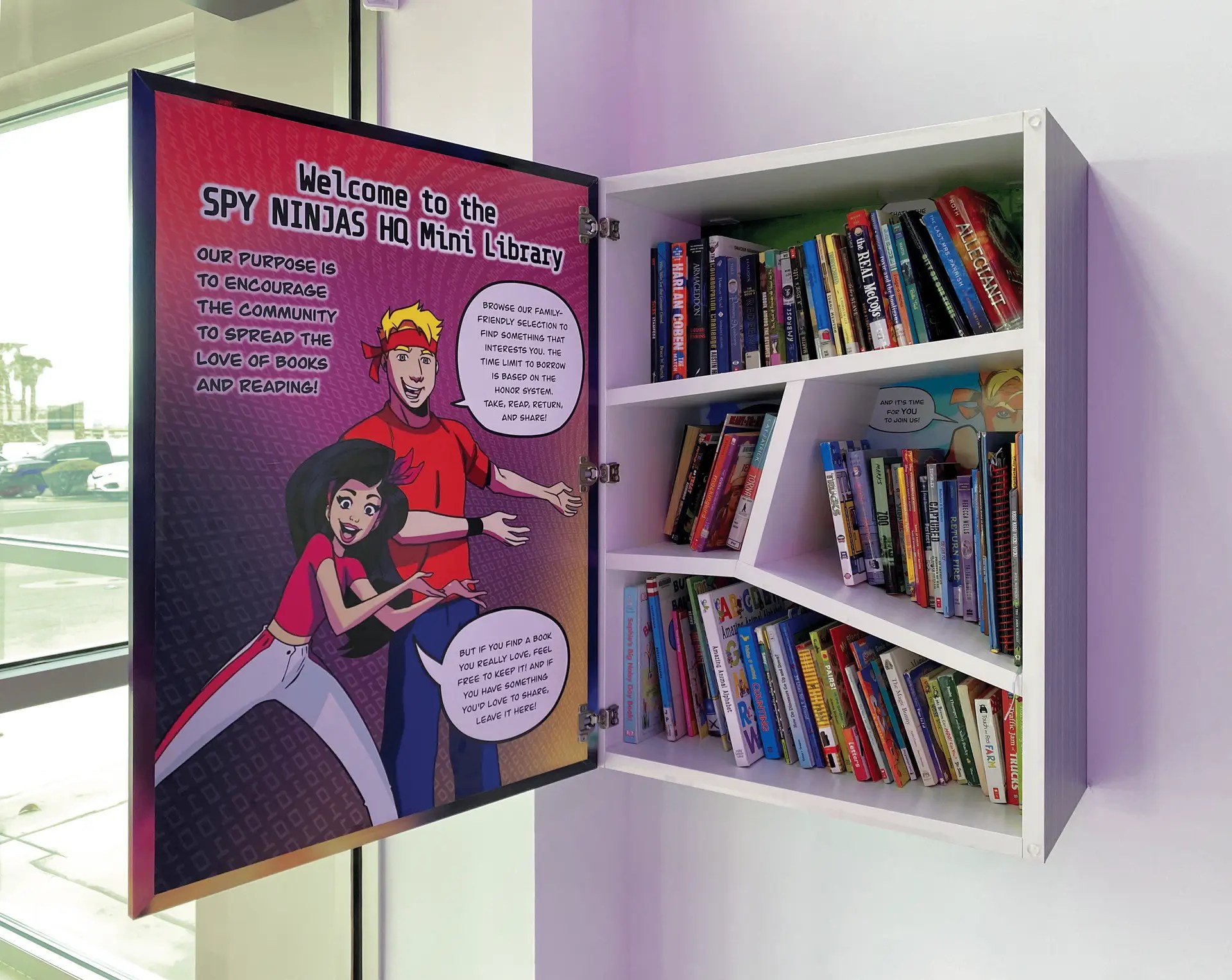 Spy Ninjas HQ's Little Free Library cabinet stocked with books for the community