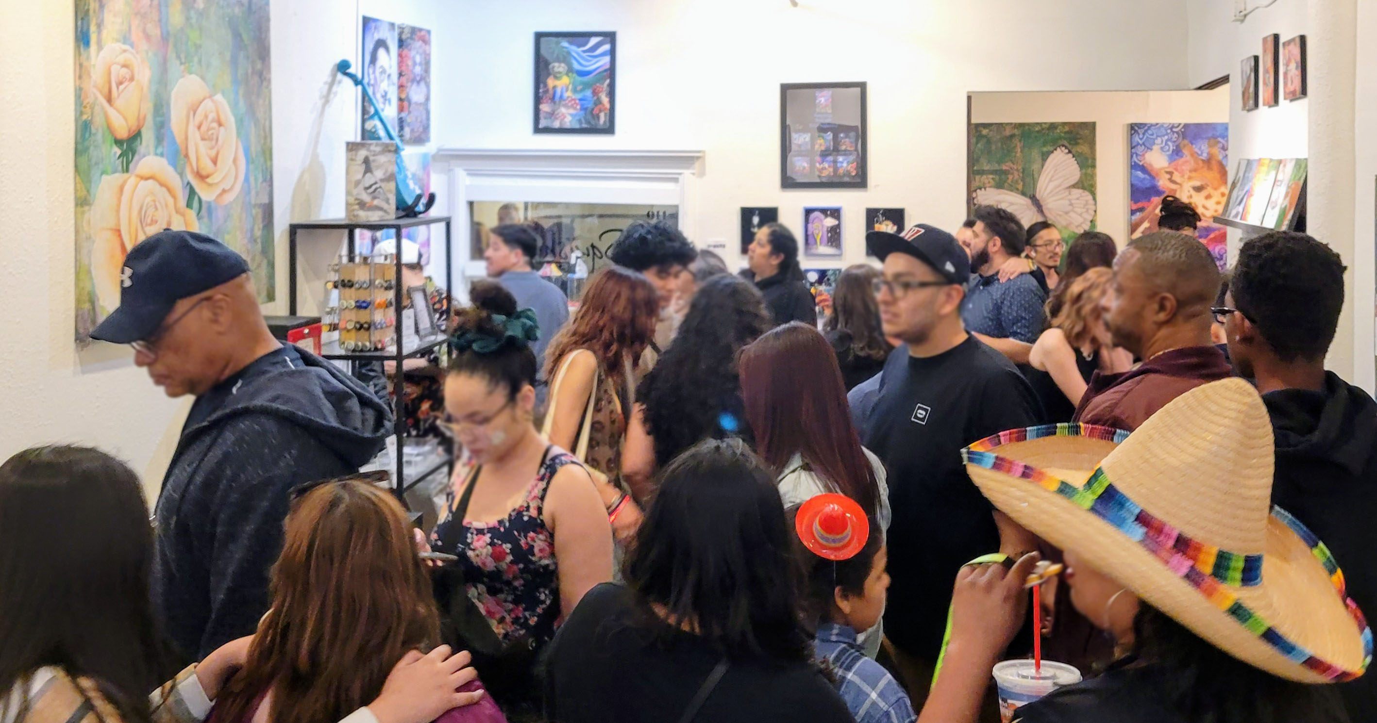 A crowd of art enthusiasts crowd the gallery on Cinco de Mayo in the Arts Factory
