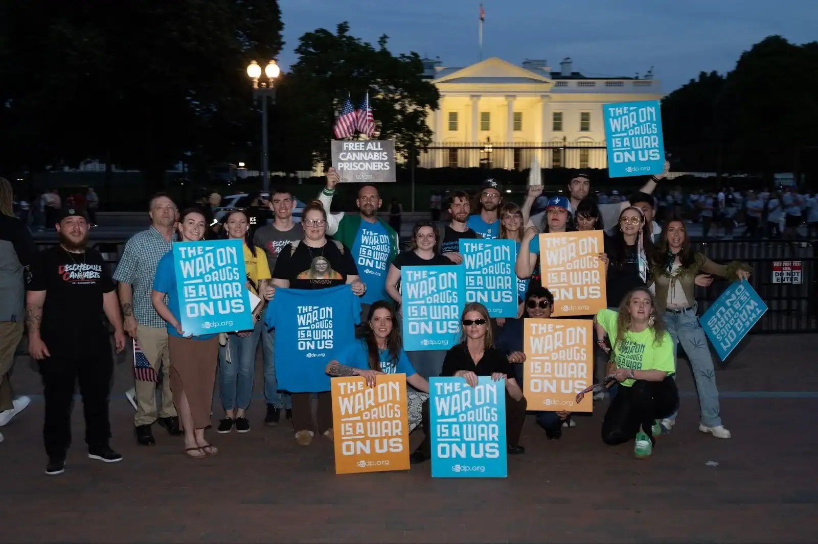 Group protesting cannabis war outside White House with signs.