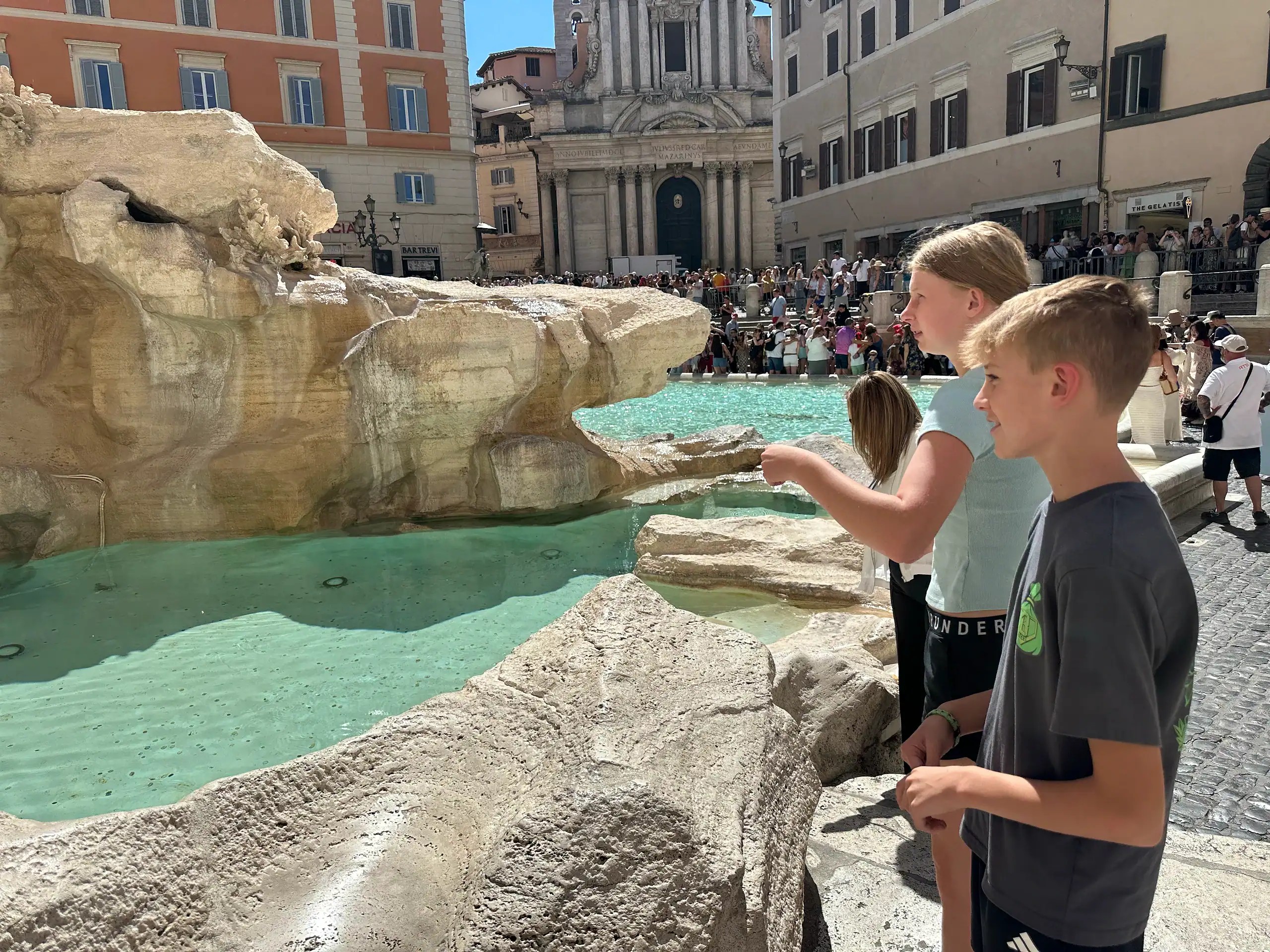 Kids visiting the Trevi Fountain during our family trip to Rome