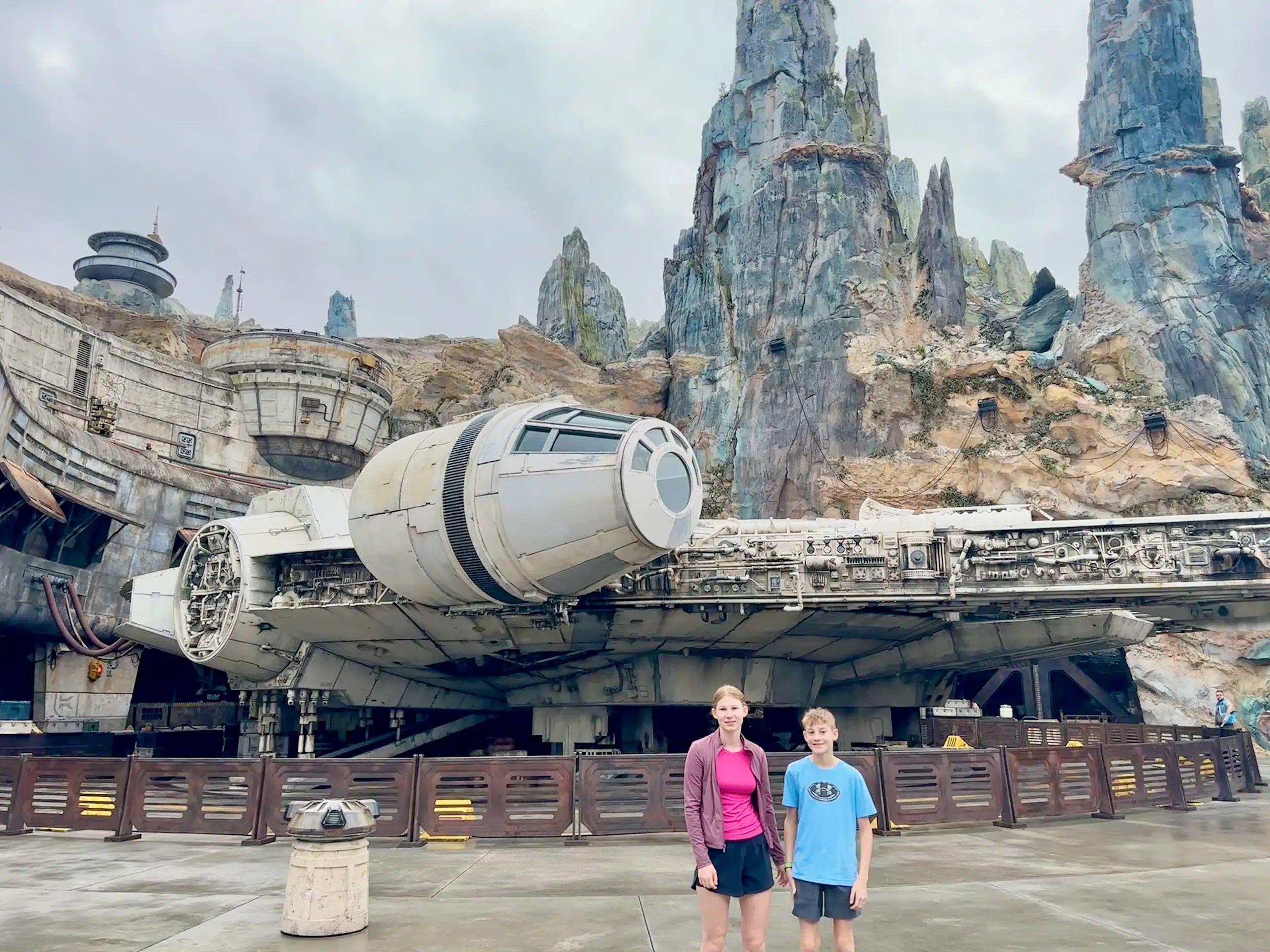 Disney with teens at Hollywood Studios standing in front of the Millennium Falcon at Star Wars: Galaxy’s Edge.