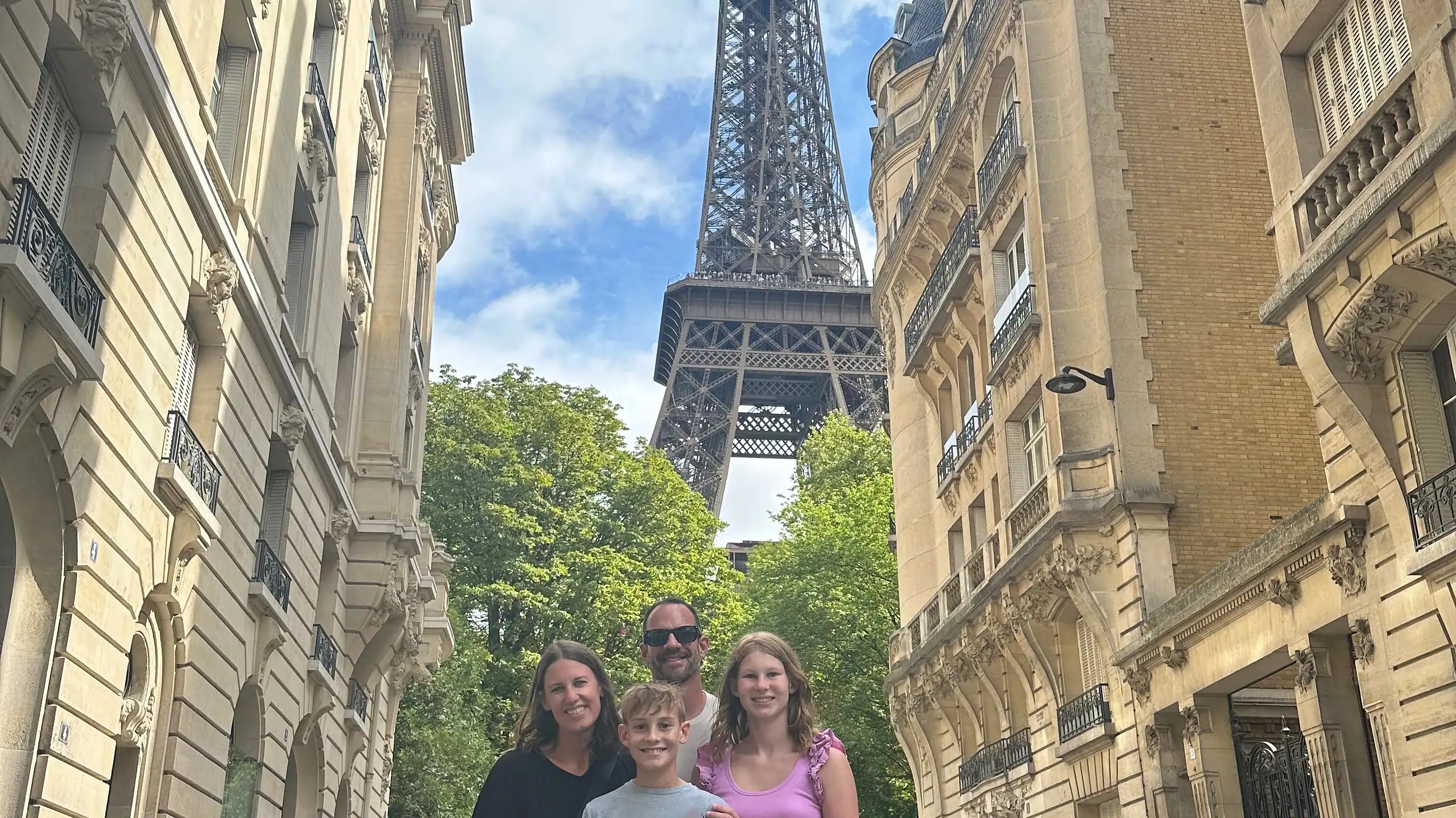 Family visiting the Eiffel Tower with kids in Paris
