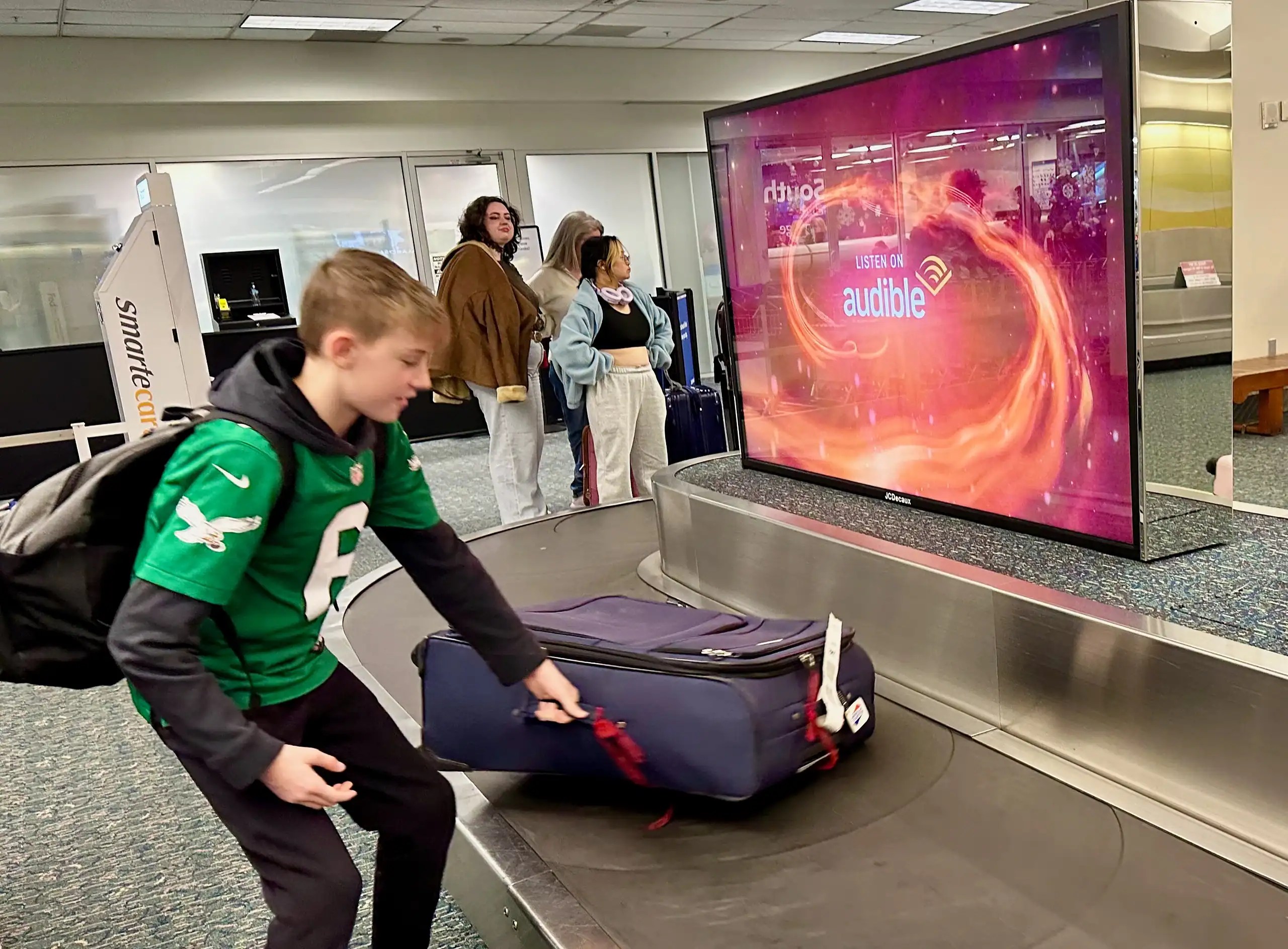 Pre-trip routine for family travel at airport baggage claim with kids