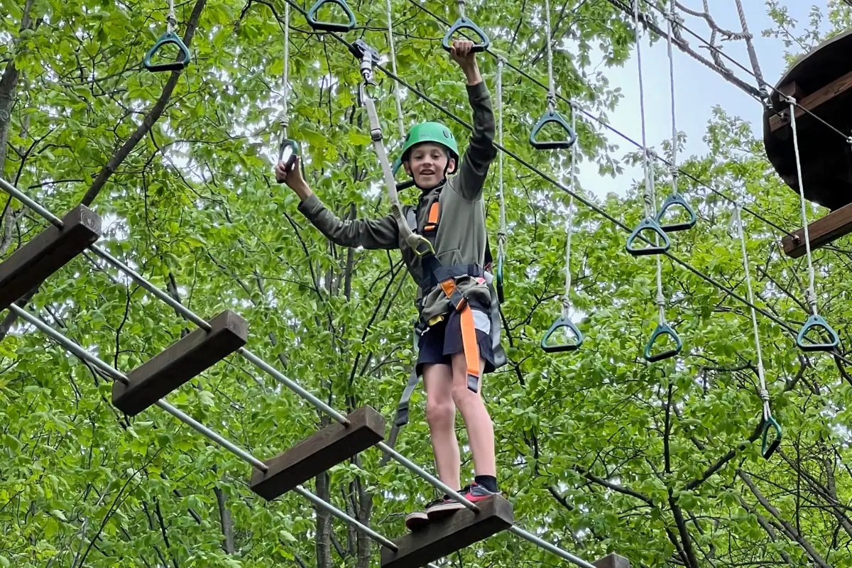 Boy crossing the ropes course at Blue Mountain Summit Adventure Park