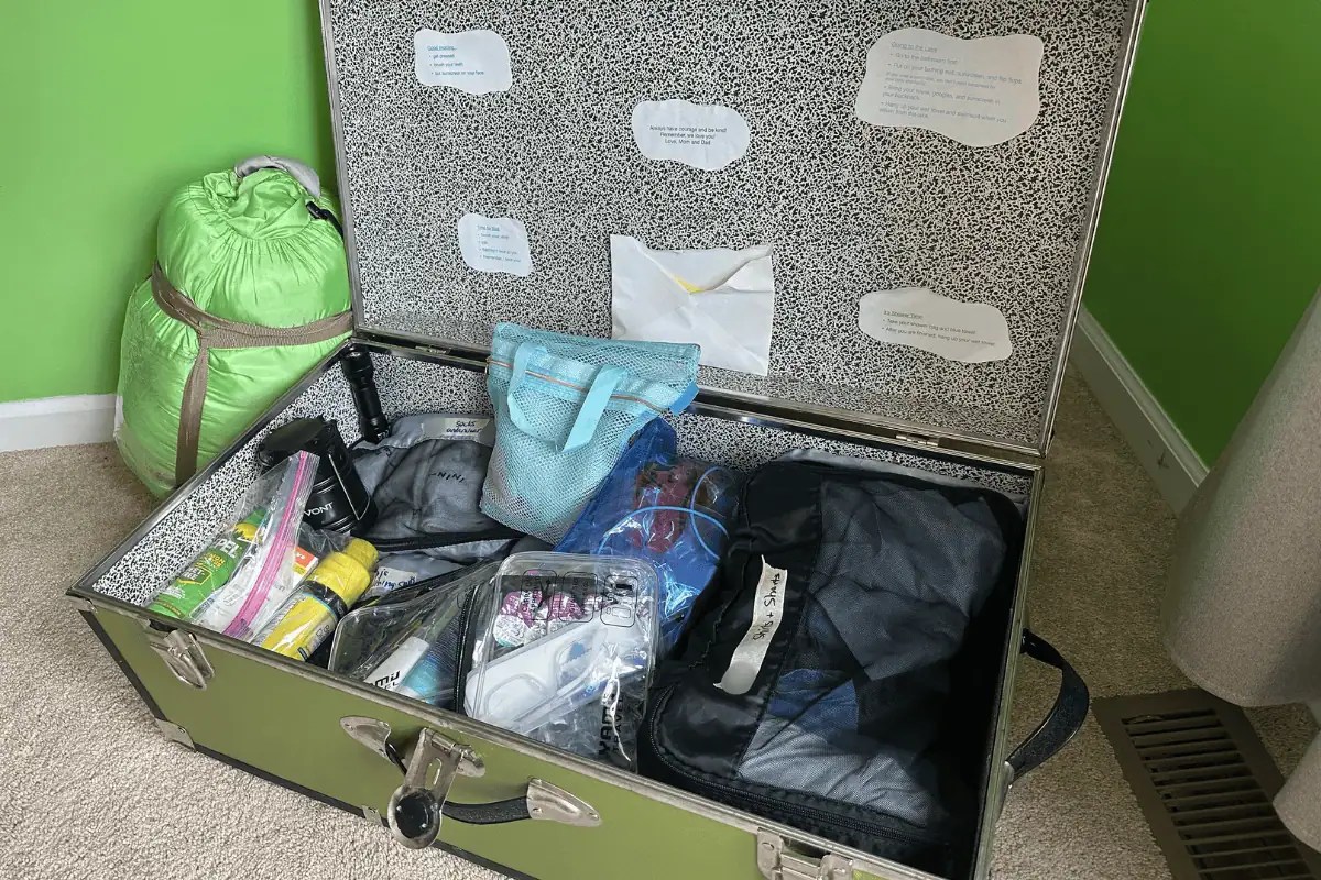 Sleepaway camp packing tips with organized camp trunk, checklist, and sleeping bag