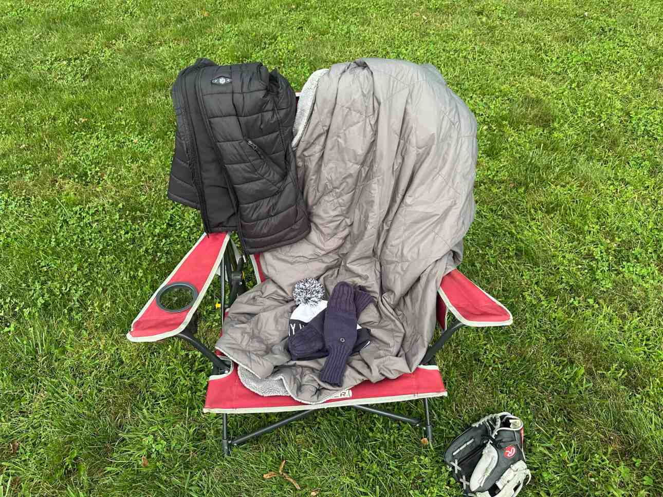 Heated blanket, heated vest, gloves and winter hat packed for a cold baseball game