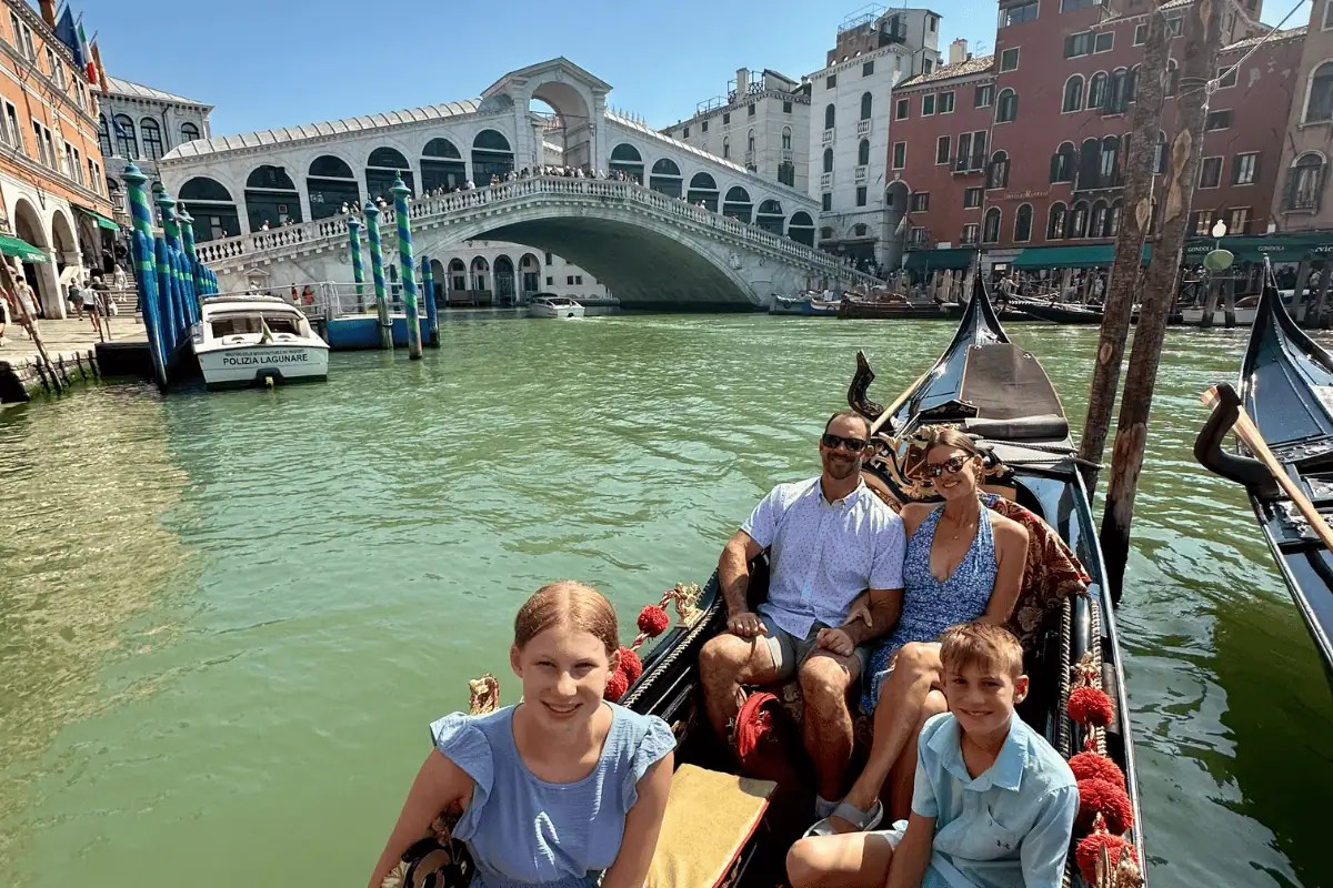 Family gondola ride near the Rialto Bridge in Venice with kids