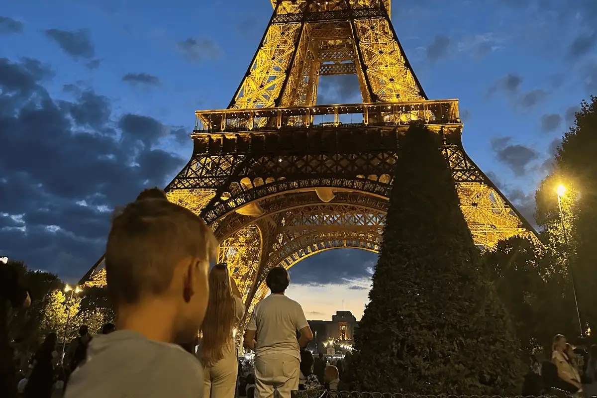 Eiffel Tower at night during our Paris in August trip with kids