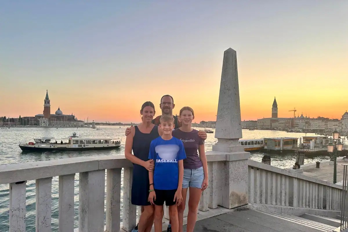 Family visiting Venice with kids at sunset