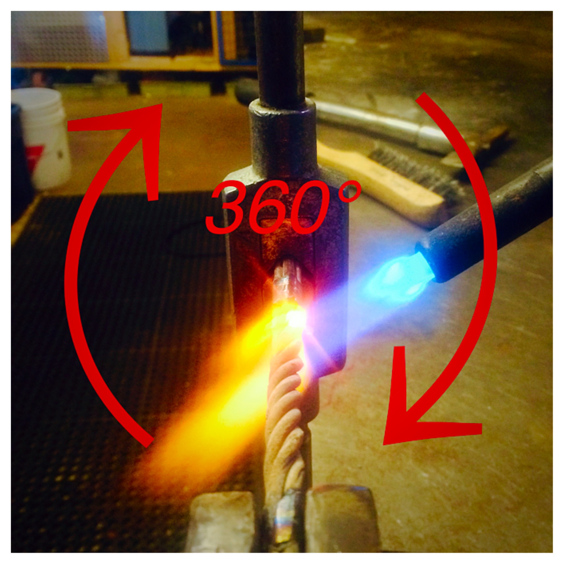 With the material pinched in the vice, begin heating at one end. Once red hot, twist the piece clockwise. Progress down the workpiece, heating and twisting.