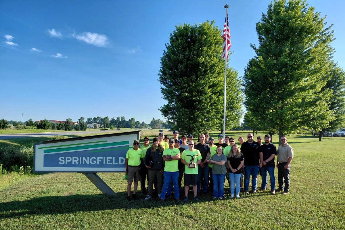 Springfield Roofing team standing outside company headquarters in Kingsley, Michigan