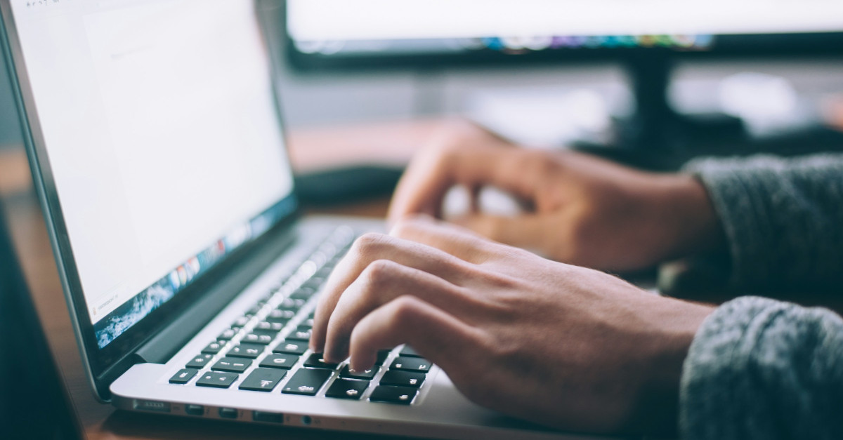 Man typing on computer.