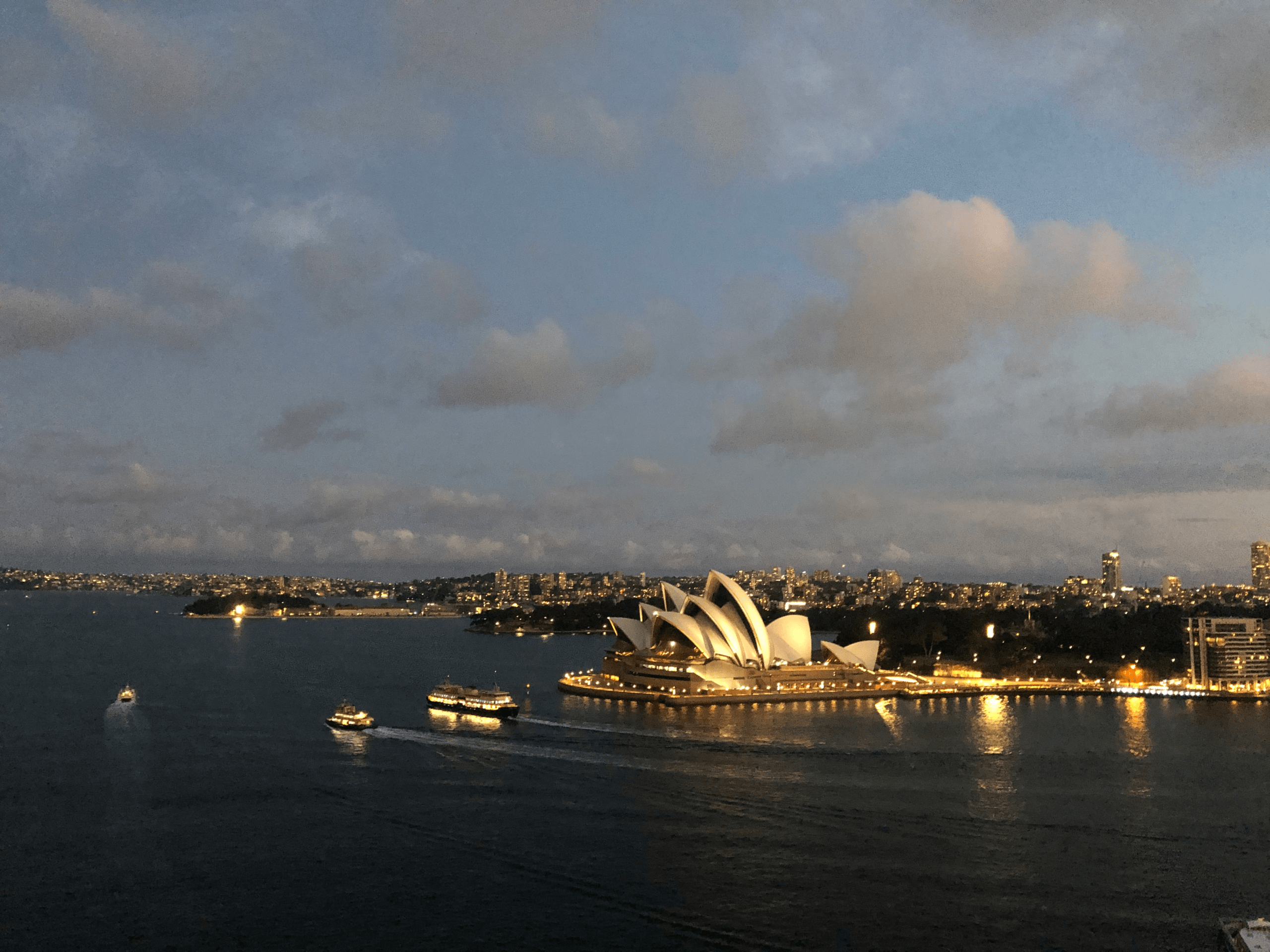 photo of Sydney Opera House in the evening with lights.