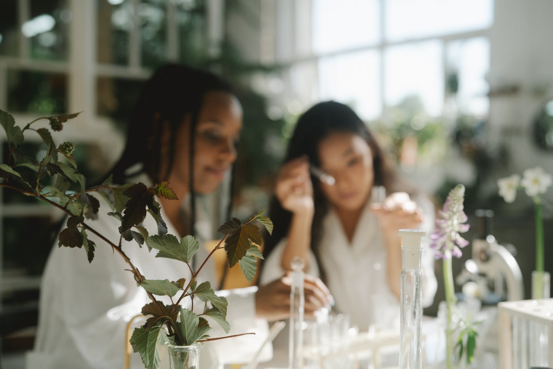 woman in white sleeveless top sitting beside woman in white sleeveless top
