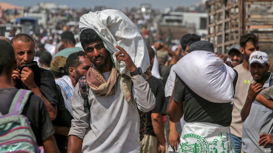 Palestinos cargan comida tras asaltar un camión con ayuda humanitaria ayer en Jan Yunis, al sur de la Franja de Gaza. Palestinos cargan comida tras asaltar un camión con ayuda humanitaria ayer en Jan Yunis, al sur de la Franja de Gaza.