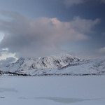 Frozen Vestpolltjonna bay. Lilandstinden-Geitgallien-Durmalsfjellet-Stortinden-Langstrandtindan-Ruiten mounts background. Austvagoya island-Nordland fylke-Norway. 0106