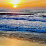 "A sunset is the sun's fiery kiss to the night"