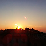 Sunset- the sun plays hide and seek with the bell tower