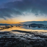 Soft and hazy aerial sunrise waterscape with boats