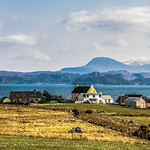 The ancient, complex and magnificent coastline of Gruinard Bay looking east from near to Mellon Udrigle. This bay has ten superb beaches. An Teallach dominates the horizon with its ten snowy peaks lost in Spring-time cloud, Wester Ross, Scotland.