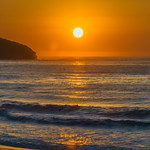 Soft hazy sunrise seascape and orange sky and full sun