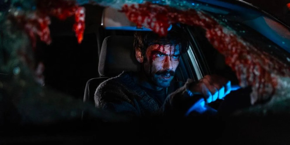 A man driving in a blood-covered car in When Evil Lurks