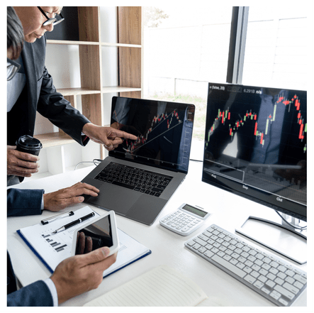 An image of two people looking at a computer monitor and a laptop with line graphs on them. The image is designed to show the statistical analysis, data analysis, business intelligence, and data science services The Statistical Consulting Firm of SC offers customers under the "statistical analysis" request. .