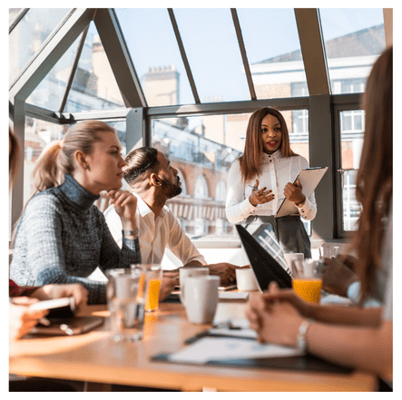 Image of a group of people sitting around a table having a workshop or a seminar. The image is designed to show how the Statistical Consulting Firm of South Carolina will do data science, statistical analysis, or business intelligence workshops in Columbia, SC for customers