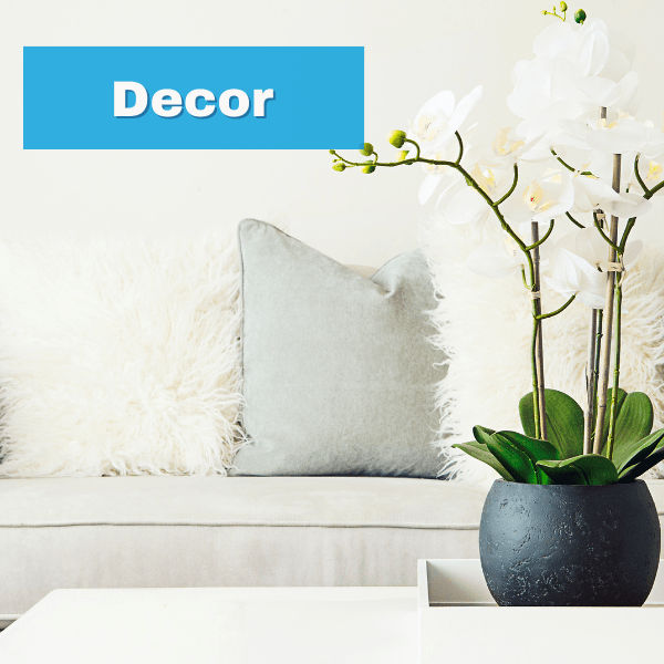Neutral home decor with pillows and orchid