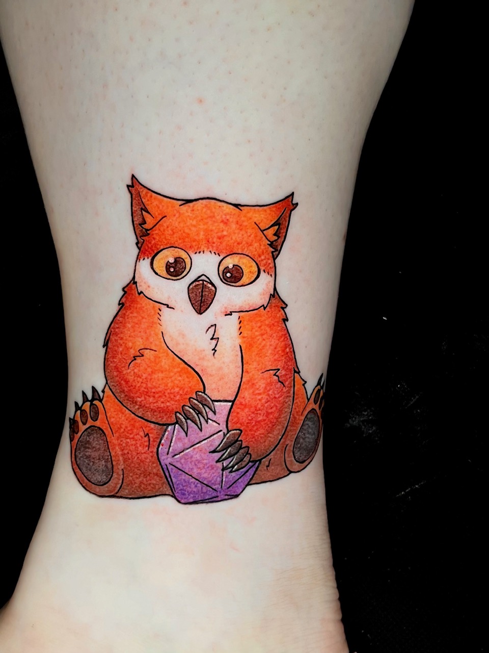 Orange Owlbear dungeons and dragons character with polyhedral dice on ankle