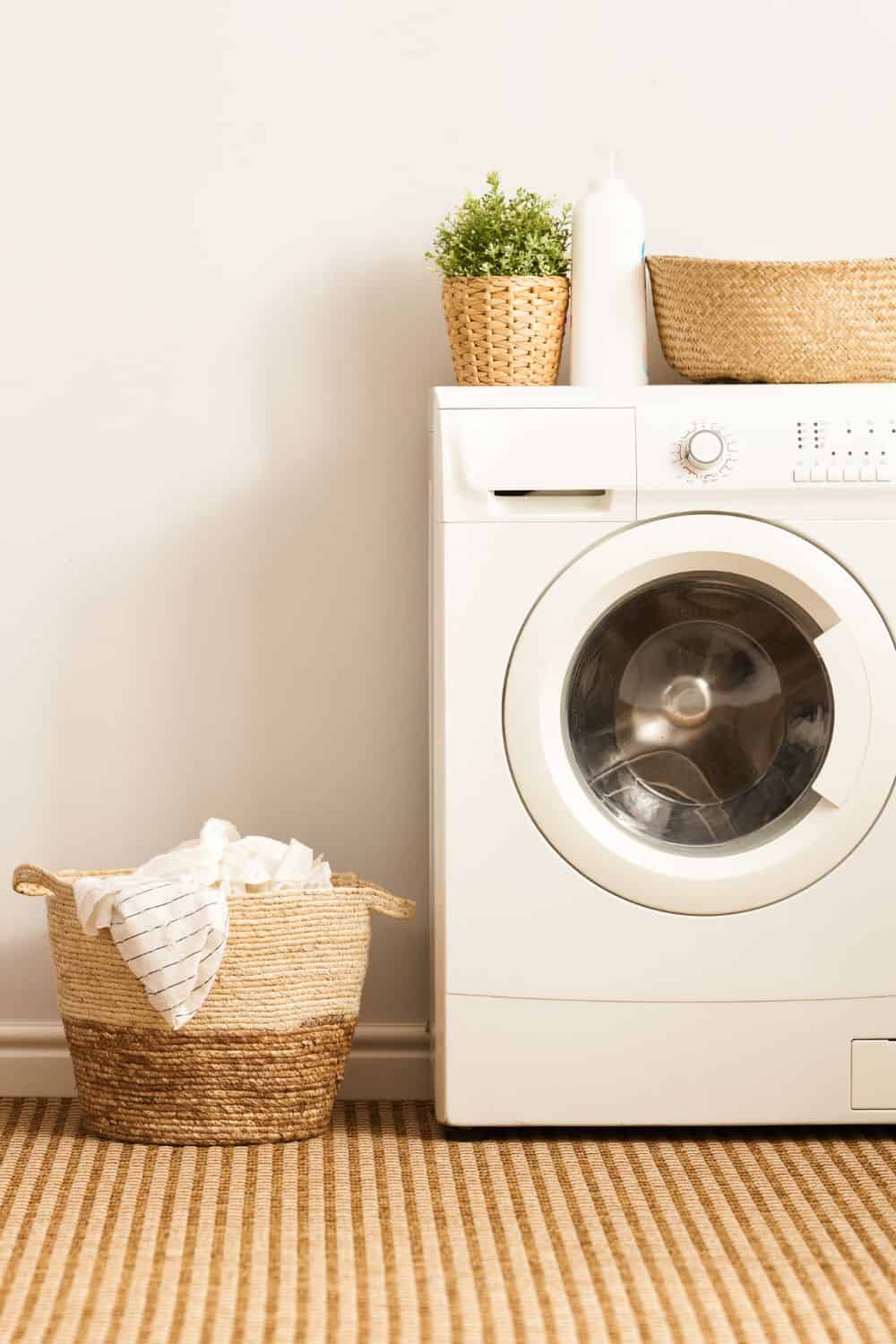 laundry machine with basket next to it