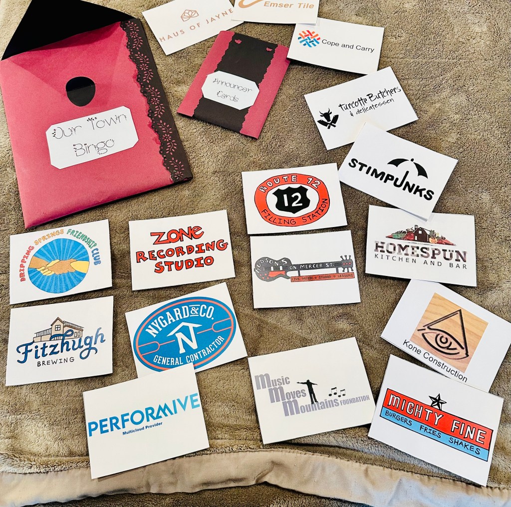 Bingo cards with company logos spread across a table