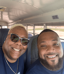 Victoria Spires, associate director of HR and operations (left), and Stephan Smith, a school bus driver for CGLA (right) are shown in their new bus.