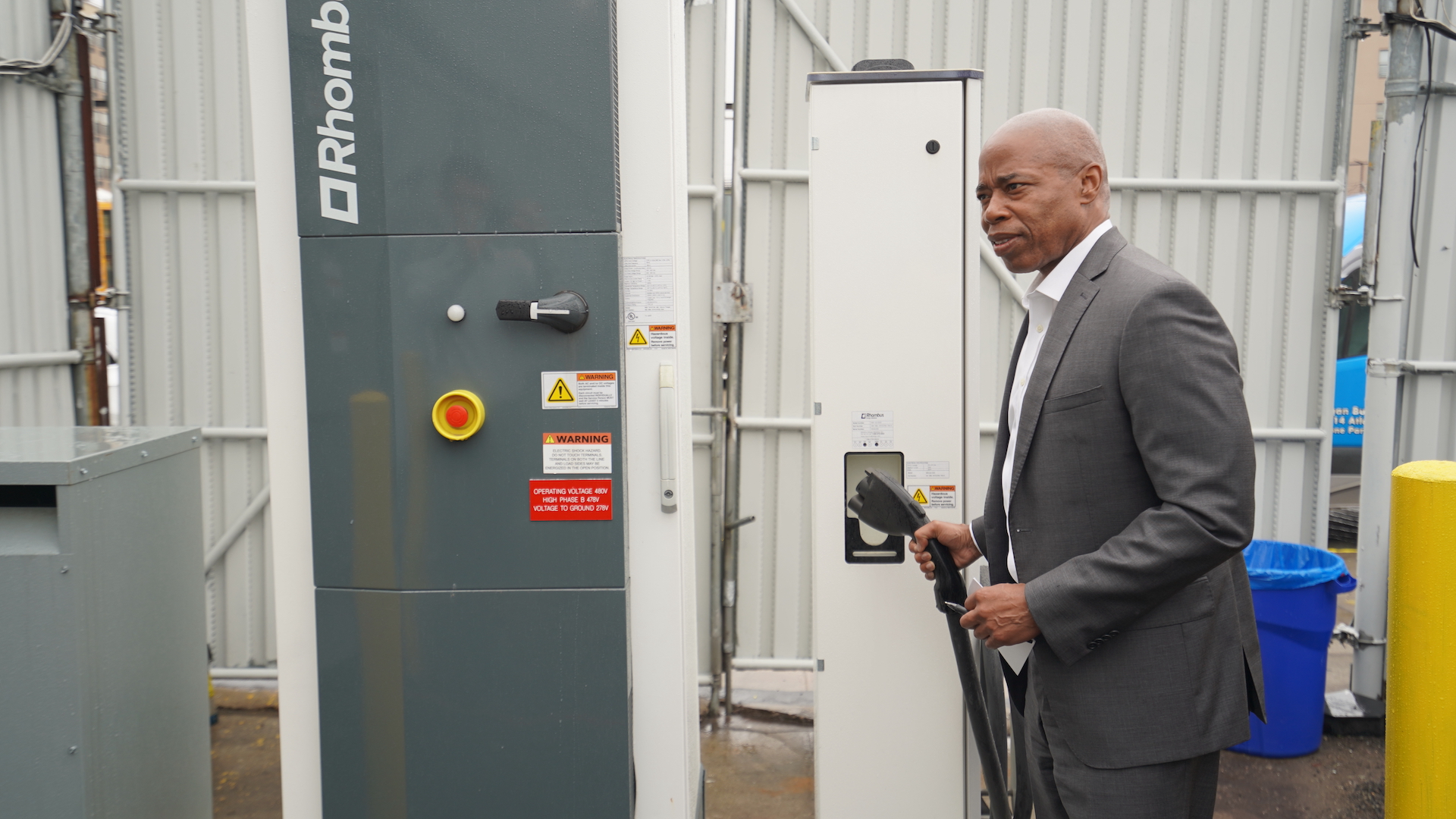 Brooklyn Borough President Eric Adams holding electric school bus charger at Logan Bus in Brooklyn, New York.
