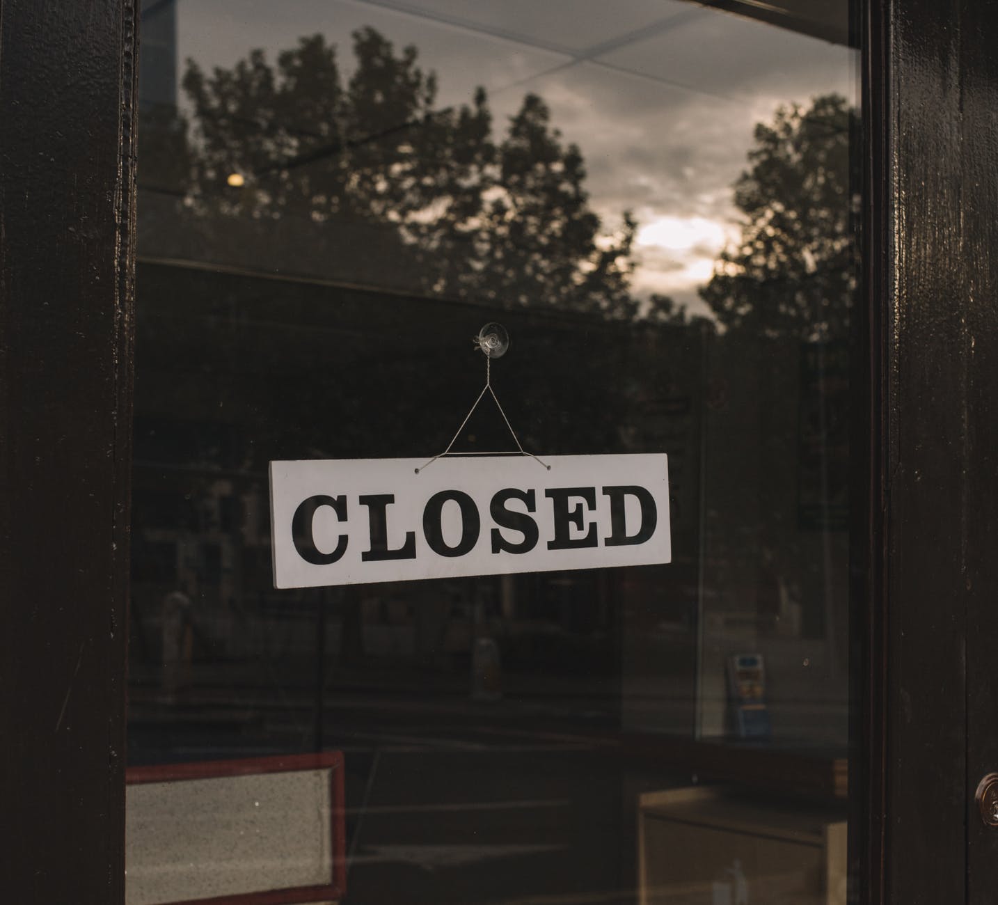 closed sign on shop glass door