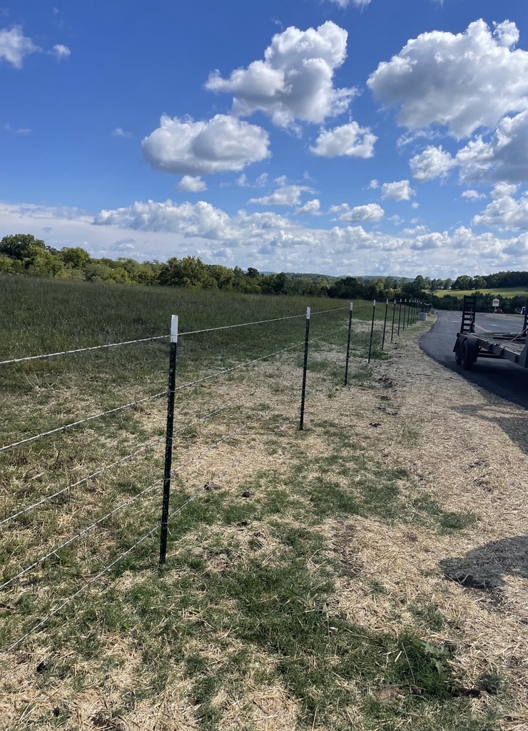 Barbed wire fence install for a farm near Nixa, MO by Stokes Fence Co.
