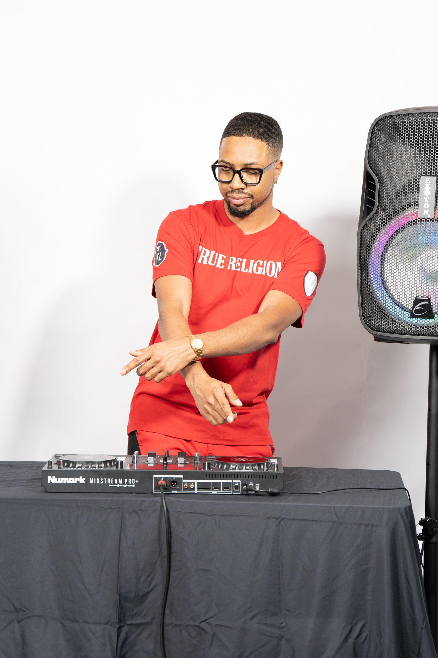 DJ Don Wan performing beside a speaker