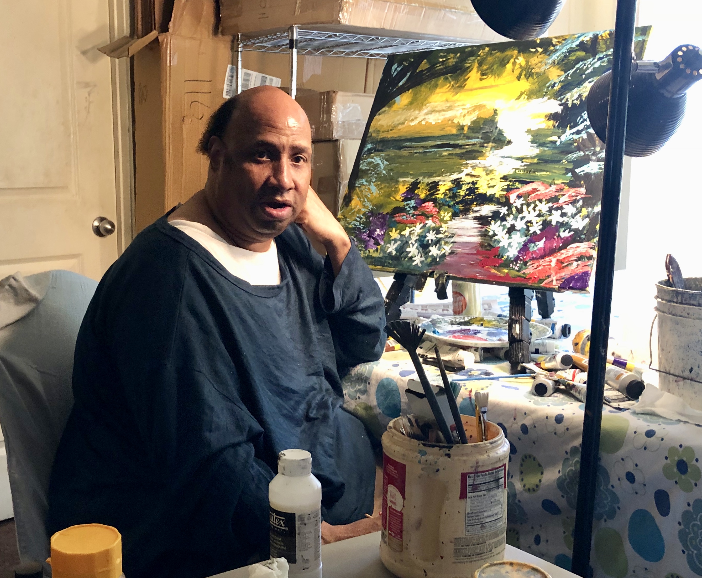Portrait of Michael William with painting of flowers along a path
