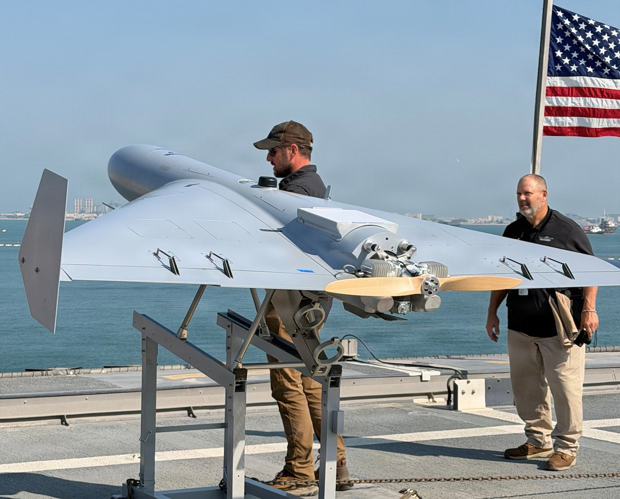 Nick Fancher, a Shipboard Weapons Integration Team weapons logistics analyst, and Rob Pavel, a logistician with Naval Air Warfare Center Weapons Division, conduct shipboard weapons integration work in support of the Low-cost Unmanned Combat Attack System aboard USS Santa Barbara (LCS 32). SWIT validates that weapons systems can be safely stored, moved, and handled at sea prior to operational use. LUCAS later successfully launched from the ship’s flight deck on December 16, 2025, as part of Task Force Scorpion Strike operations while operating in the Arabian Gulf | Photo: Naval Air Warfare Center Weapons Division