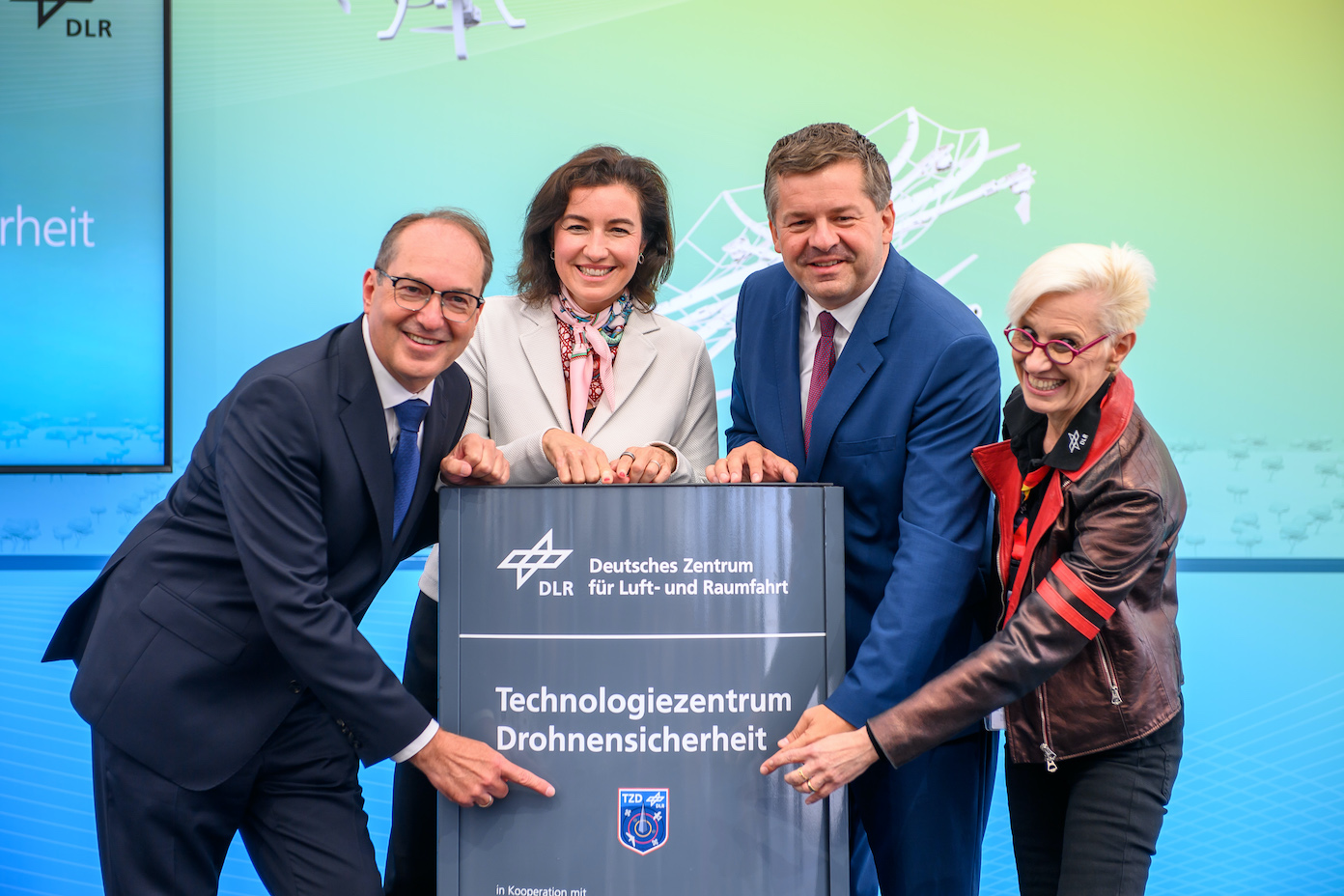 German Interior Minister Alexander Dobrindt, Dorothee Baer, German Minister of Research, Technology, and Space; Sven Schulze, Minister-President of Saxony-Anhalt, and Anke Kaysser-Pyzalla, Chairwoman of the Executive Board of the German Aerospace Center (DLR), open the Technology Center for Drone Safety and unveil the commemorative plaque bearing the institution's name | Photo: Klaus-Dietmar Gabbert/dpa