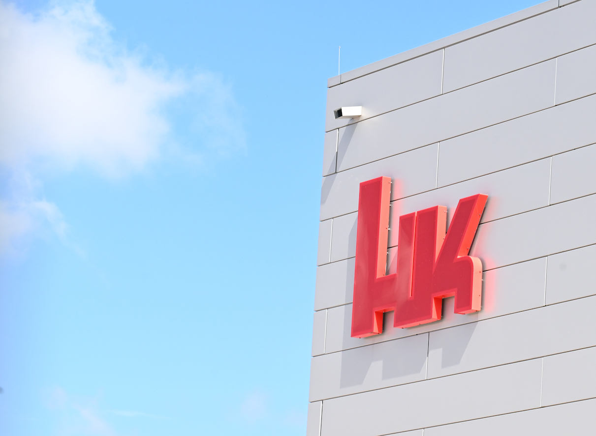 The logo of the firearms manufacturer Heckler & Koch is displayed on a building at its headquarters | File Photo: Bernd Weiﬂbrod/dpa